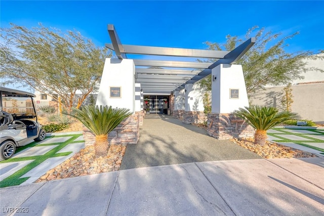 view of front of property with a pergola and stucco siding