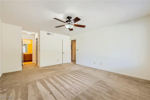 interior space featuring light carpet, a ceiling fan, visible vents, and baseboards