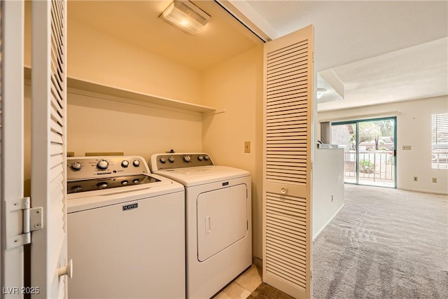 laundry room with washing machine and dryer, laundry area, and light carpet