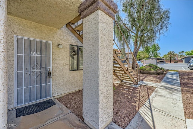 entrance to property with stucco siding