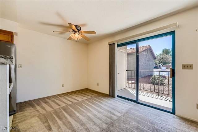 interior space with light colored carpet and a ceiling fan