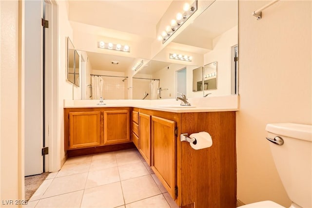 full bathroom featuring toilet, a sink, and tile patterned flooring