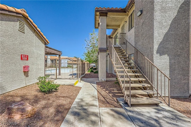 surrounding community with fence and stairs