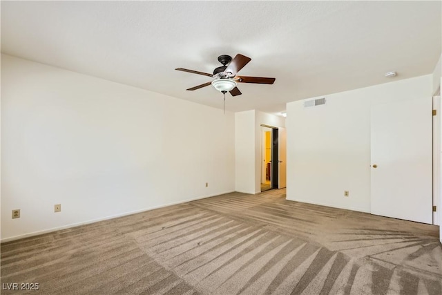 unfurnished room with visible vents, a ceiling fan, and light colored carpet