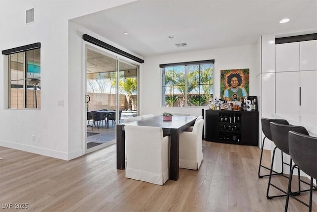 dining space featuring visible vents, baseboards, and light wood-type flooring