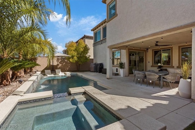 view of pool with a patio area, a fenced backyard, ceiling fan, and a pool with connected hot tub
