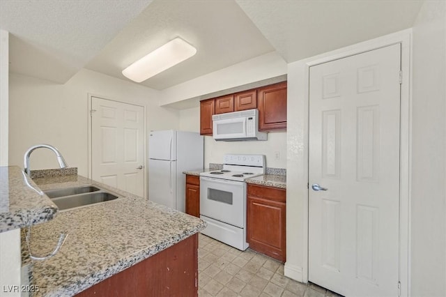 6800 E Lake Mead Blvd Unit 2050, Las Vegas, NV 89156 - kitchen featuring white appliances, a sink, and light stone counters