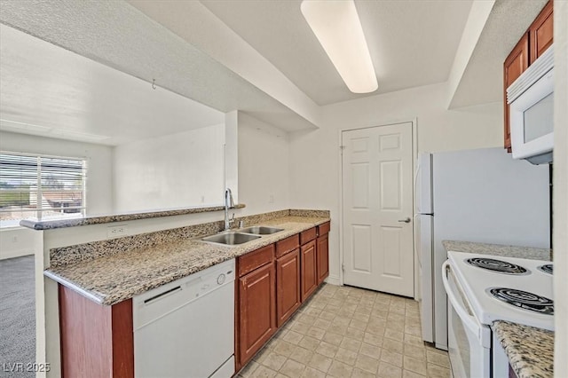 6800 E Lake Mead Blvd Unit 2050, Las Vegas, NV 89156 - kitchen featuring white appliances, a sink, a peninsula, and light stone countertops