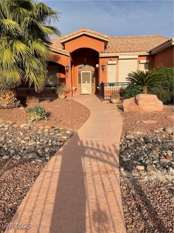210 Lailani St, Las Vegas, NV 89110 - view of front of house with a tiled roof, covered porch, and stucco siding