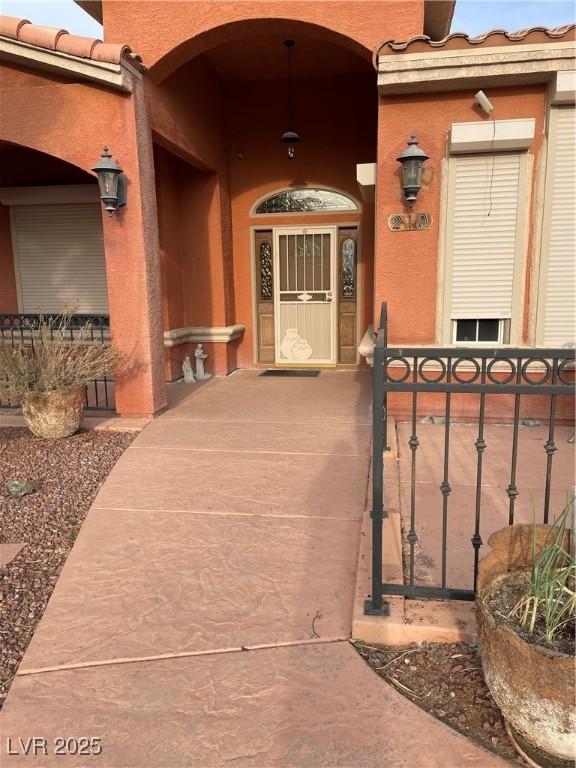 210 Lailani St, Las Vegas, NV 89110 - entrance to property with stucco siding, a tile roof, and a gate