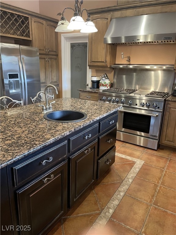 210 Lailani St, Las Vegas, NV 89110 - kitchen featuring dark stone countertops, light tile patterned floors, wall chimney exhaust hood, a sink, and appliances with stainless steel finishes