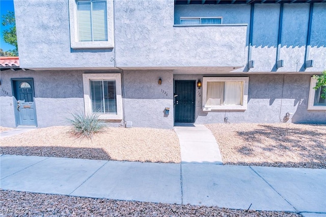 property entrance featuring stucco siding