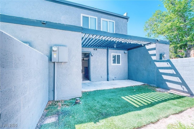 back of house with a patio, stucco siding, and fence