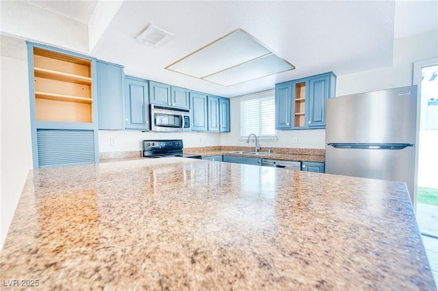 kitchen with visible vents, open shelves, a sink, appliances with stainless steel finishes, and blue cabinetry
