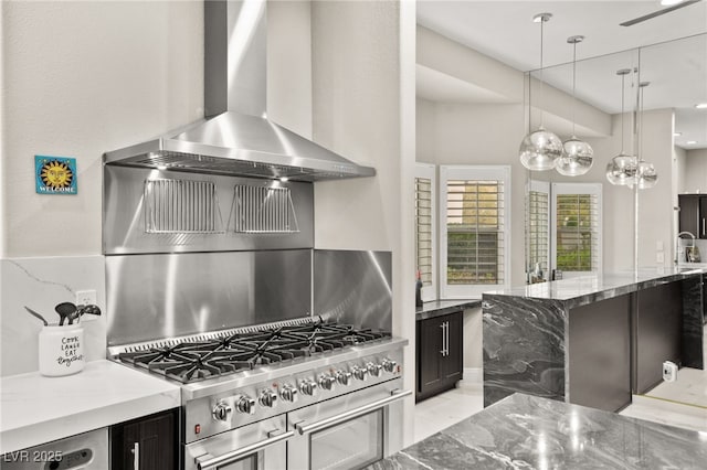 2608 Sun Reef Rd, Las Vegas, NV 89128 - kitchen featuring stone counters, dark cabinets, range, decorative light fixtures, and wall chimney exhaust hood