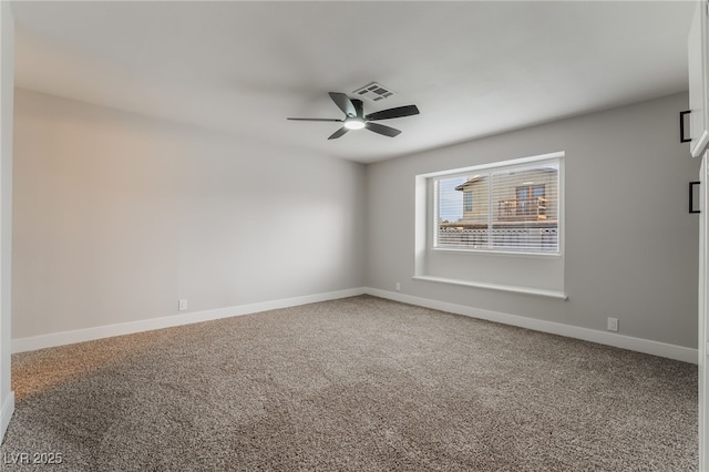 empty room featuring carpet floors, baseboards, a ceiling fan, and visible vents