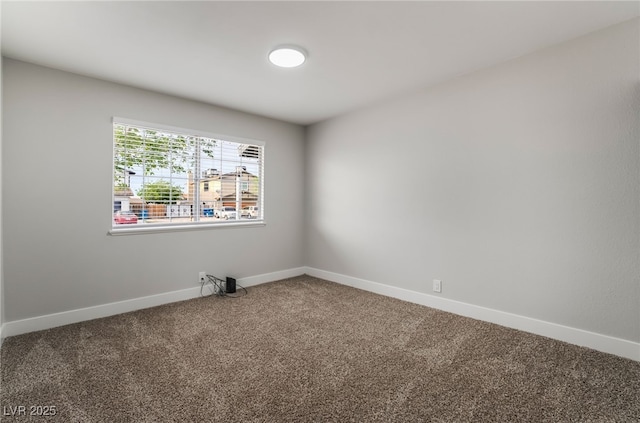 empty room with carpet flooring and baseboards
