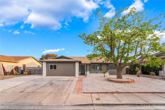 single story home featuring fence and concrete driveway