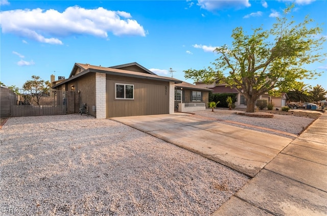 view of front of home with driveway and fence