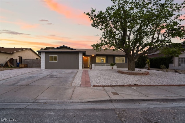 view of front of property with fence and concrete driveway