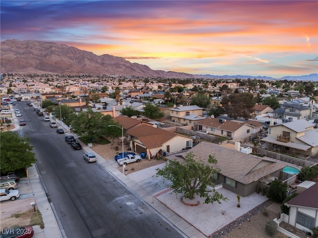 aerial view at dusk with a mountain view and a residential view