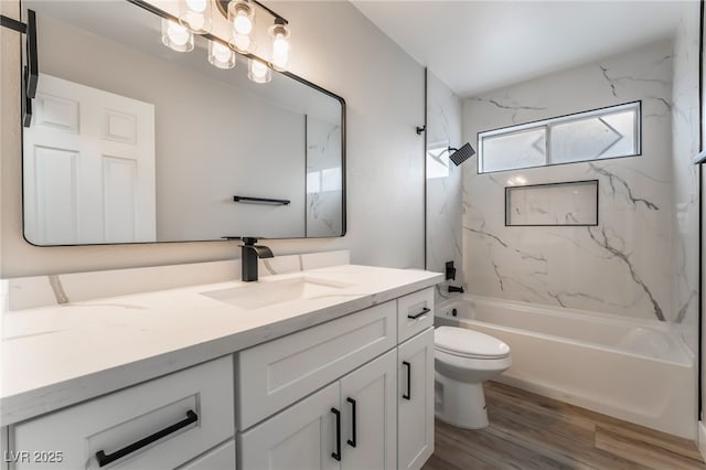 bathroom featuring vanity,  shower combination, toilet, and wood finished floors