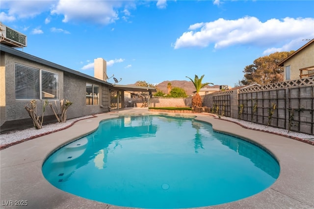 view of pool featuring a fenced backyard, a fenced in pool, and a patio