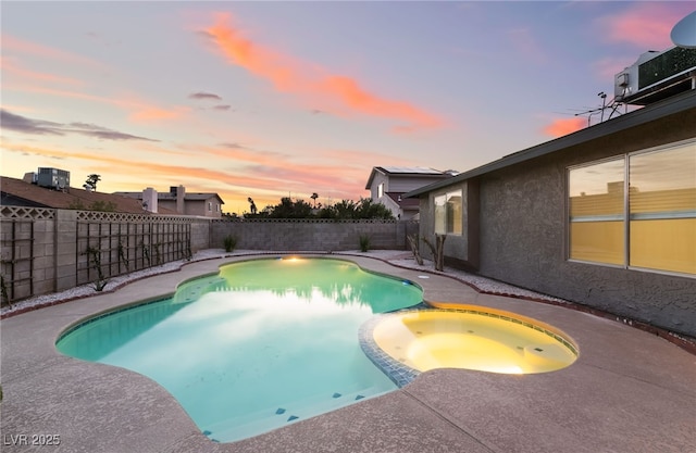 view of pool featuring central AC, a fenced backyard, a pool with connected hot tub, and a patio