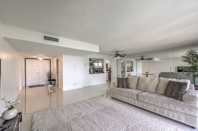 living area with ceiling fan, tile patterned flooring, and visible vents