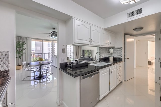 205 E Harmon Ave Unit 803, Las Vegas, NV 89169 - kitchen featuring stainless steel dishwasher, dark countertops, white cabinetry, a ceiling fan, and decorative backsplash