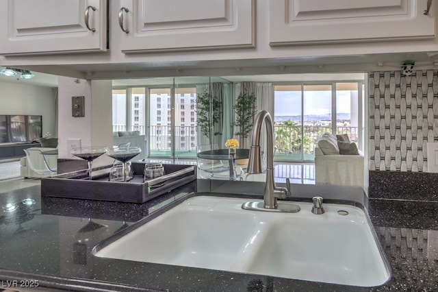 205 E Harmon Ave Unit 803, Las Vegas, NV 89169 - kitchen view of white cabinets and dark stone countertops
