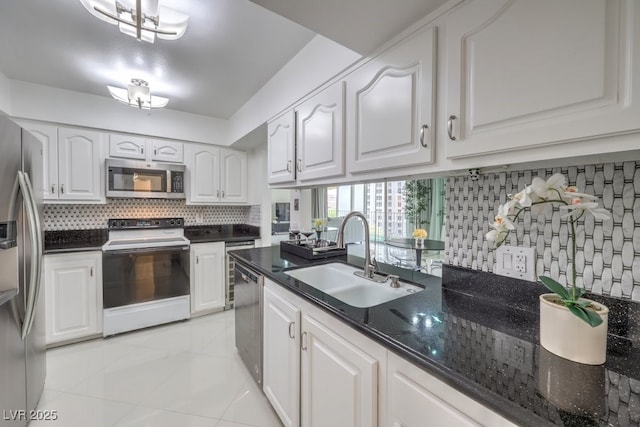 205 E Harmon Ave Unit 803, Las Vegas, NV 89169 - kitchen with stainless steel appliances, light tile patterned floors, white cabinetry, tasteful backsplash, and dark stone counters