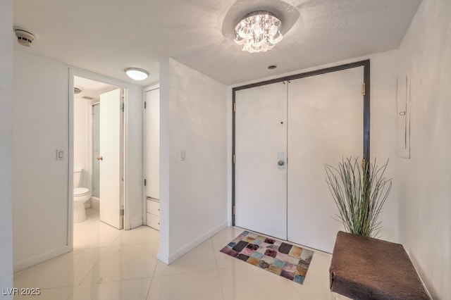 205 E Harmon Ave Unit 803, Las Vegas, NV 89169 - tiled foyer with baseboards and a chandelier