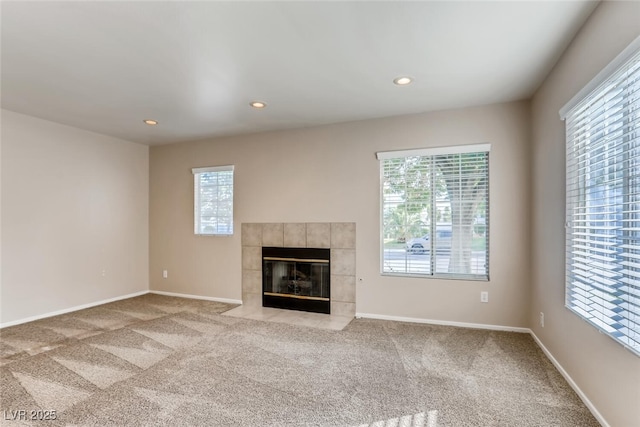 unfurnished living room with a fireplace, carpet, and baseboards