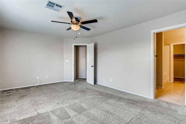 unfurnished bedroom featuring visible vents, baseboards, ceiling fan, and carpet
