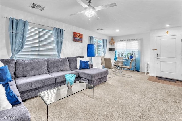 living room featuring carpet floors, recessed lighting, ceiling fan, and visible vents