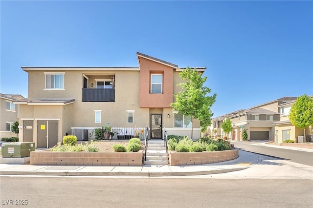 townhome / multi-family property with central AC unit and stucco siding