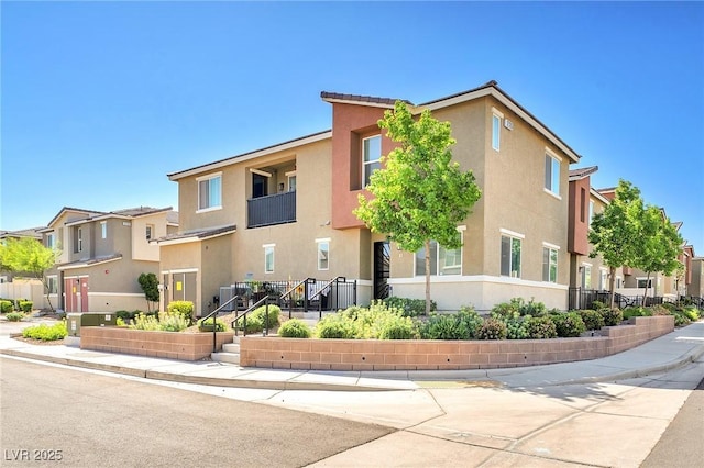 view of front facade with a residential view and stucco siding