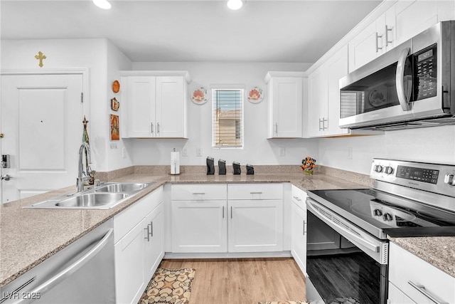 kitchen featuring a sink, appliances with stainless steel finishes, recessed lighting, and white cabinetry