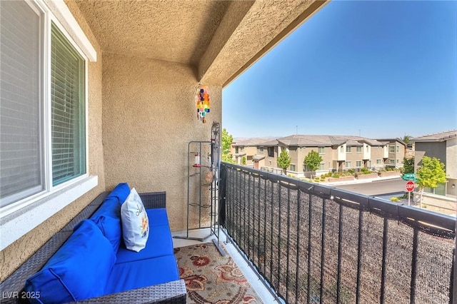 balcony featuring an outdoor hangout area and a residential view