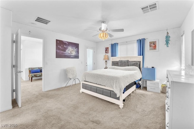 bedroom with light carpet, a ceiling fan, and visible vents