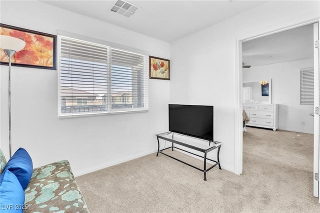 sitting room with carpet floors, baseboards, and visible vents
