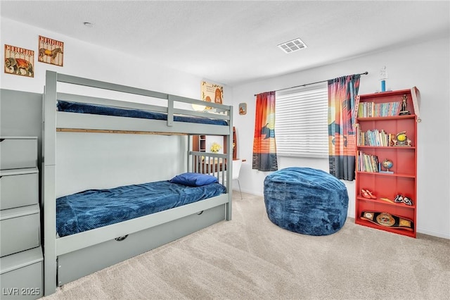 bedroom with baseboards, carpet flooring, and visible vents