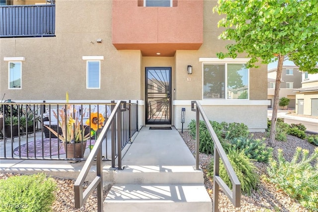 property entrance featuring stucco siding