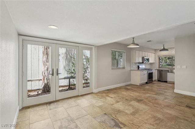 interior space with french doors, baseboards, and visible vents