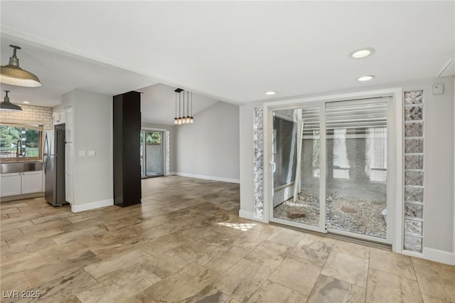 interior space featuring stone finish flooring, recessed lighting, baseboards, and a sink