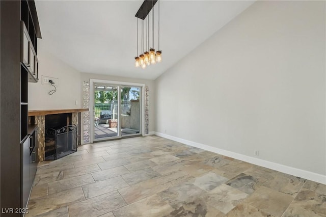 unfurnished living room featuring stone tile flooring, baseboards, high vaulted ceiling, and a fireplace