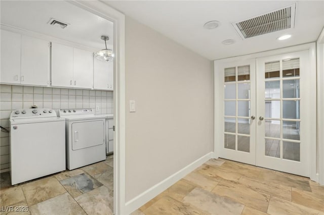 laundry area with washer and dryer, visible vents, french doors, and cabinet space