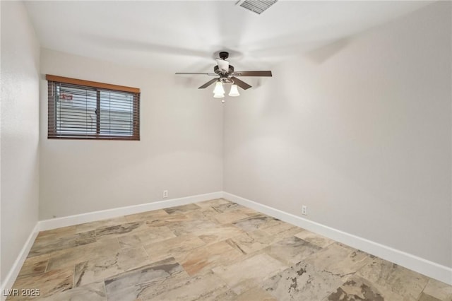 empty room with visible vents, baseboards, and ceiling fan