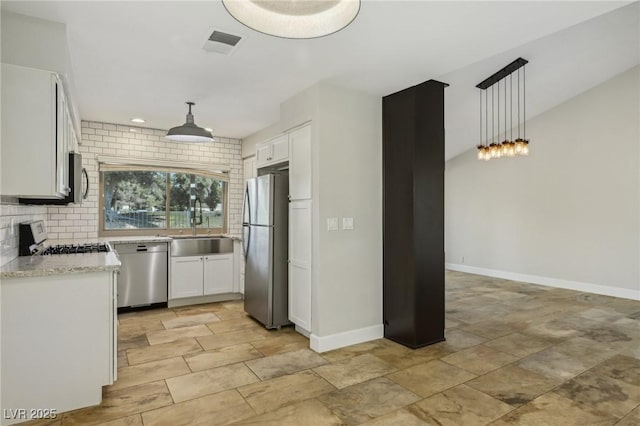 kitchen with visible vents, white cabinets, baseboards, appliances with stainless steel finishes, and pendant lighting
